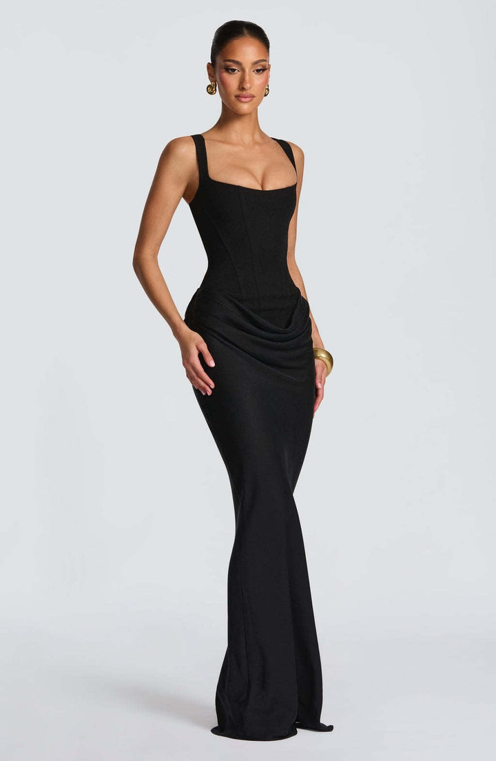 Elegant women's long maxi dress. Corset bodice, wide straps, & draped skirt. Sophisticated formal evening wear.