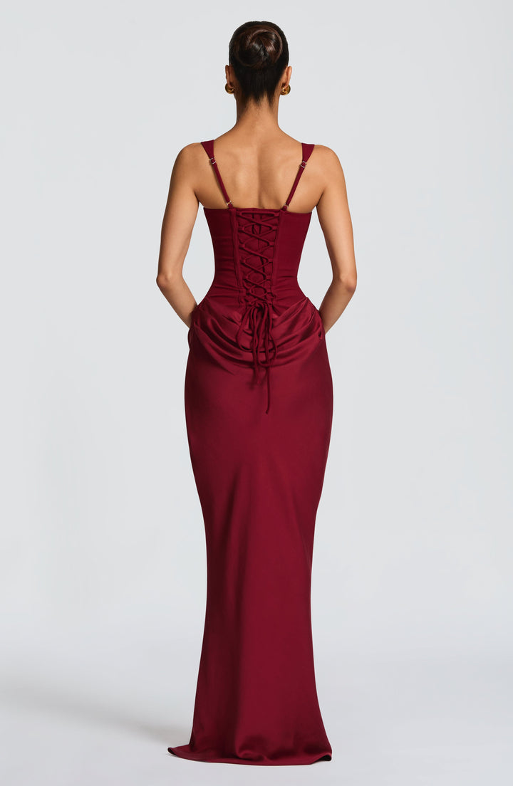 Sleeveless women's maxi dress with wide straps and a structured corset bodice. Elegant formal or party attire.