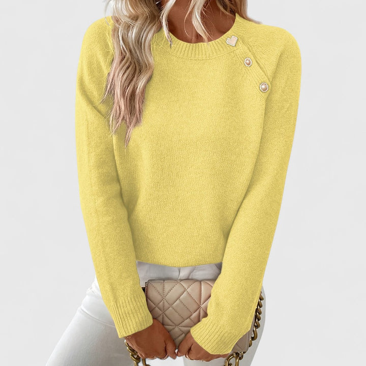Woman wearing a comfortable and elegant crew neck pullover sweater with pearl buttons.
