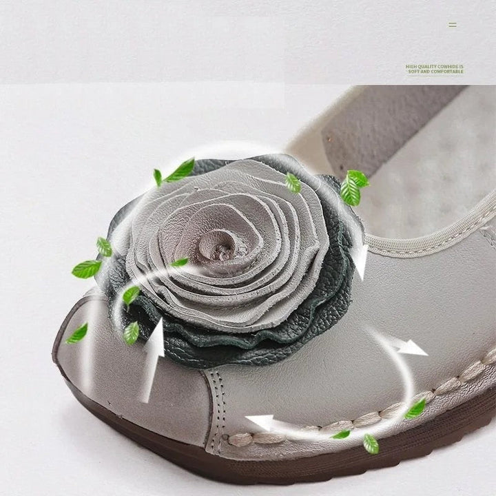 Slip-on women's comfort loafers, adorned with floral appliqué, perfect for walking.