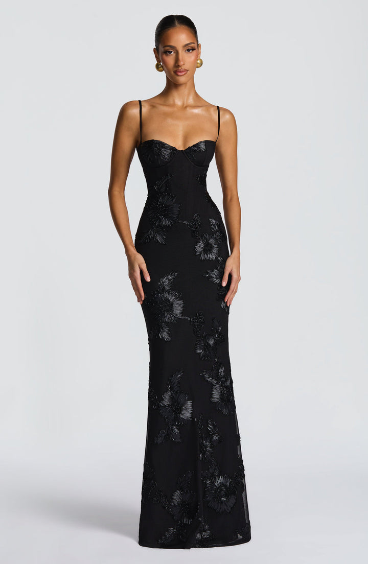 Stylish women's floral print maxi dress featuring a structured corset top and delicate spaghetti straps, ideal for parties.