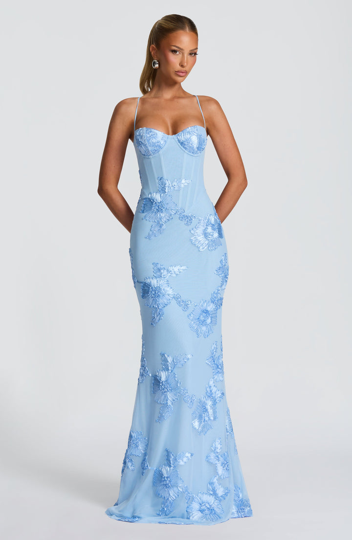 Chic floral maxi dress for women, designed as a wedding guest outfit, with a flattering corset and elegant long skirt.