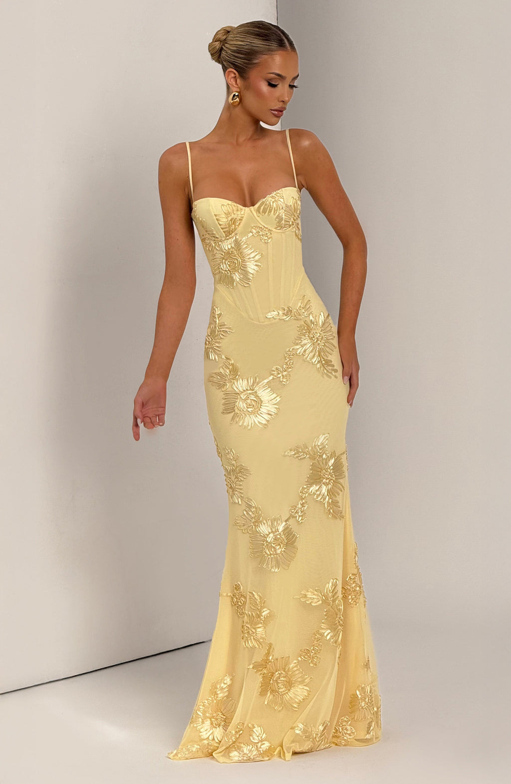 Elegant women's floral evening gown, a maxi dress with a refined corset, spaghetti straps & low back, suited for formal events.