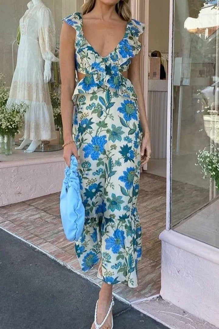 Full-length view of a woman wearing a floor-length floral ruffle maxi dress, showcasing its flowy style.