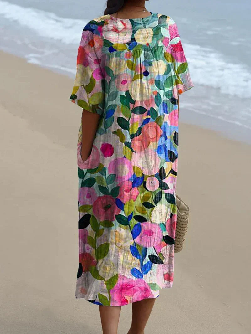 Comfortable women's floral V-neck short sleeve midi dress. Perfect oversized fit for a chic summer, beach day, or brunch outfit.