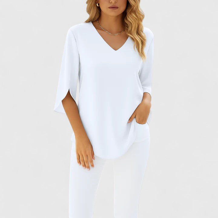 Feminine women's flowy blouse featuring stylish split sleeves. Ideal versatile top for both office and casual wear.