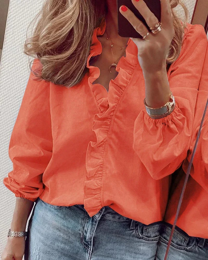 Women's elegant long sleeve V-neck blouse with ruffle trim, perfect for office or casual wear.