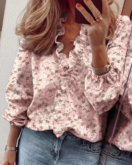 Fashionable women's long sleeve blouse with a flattering V-neck and stylish ruffle trim detail.