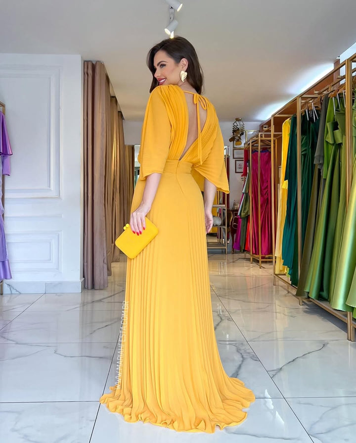 Women's elegant pleated batwing maxi party dress. Ideal for wedding guests, formal celebrations, or special evening wear.