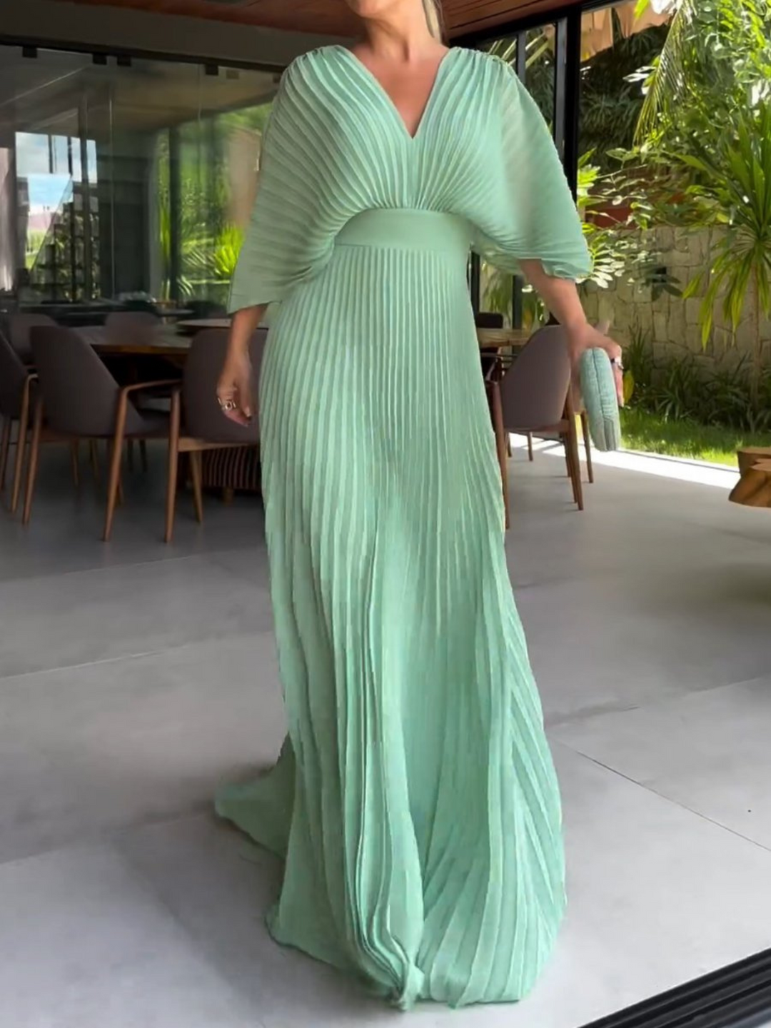 Sophisticated women's wedding guest maxi dress featuring pleated details & stylish batwing sleeves. Formal evening wear.