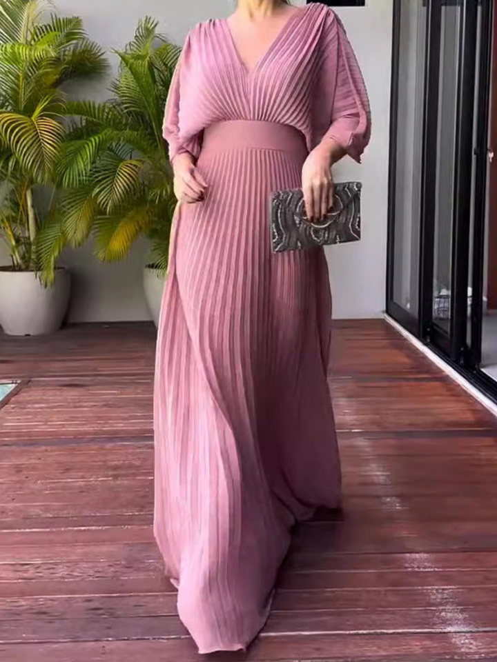 Women's V-neck pleated maxi gown with batwing sleeves, perfect as an elegant wedding guest or special occasion dress.