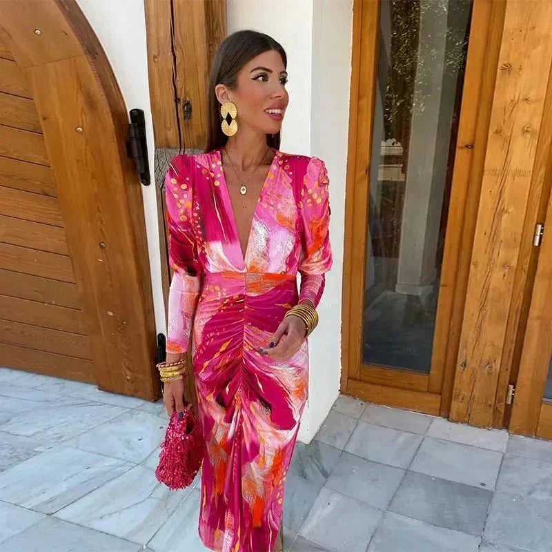 V-neck long-sleeve printed ruched midi dress for women. A stylish and comfortable choice for wedding guests or evening events.