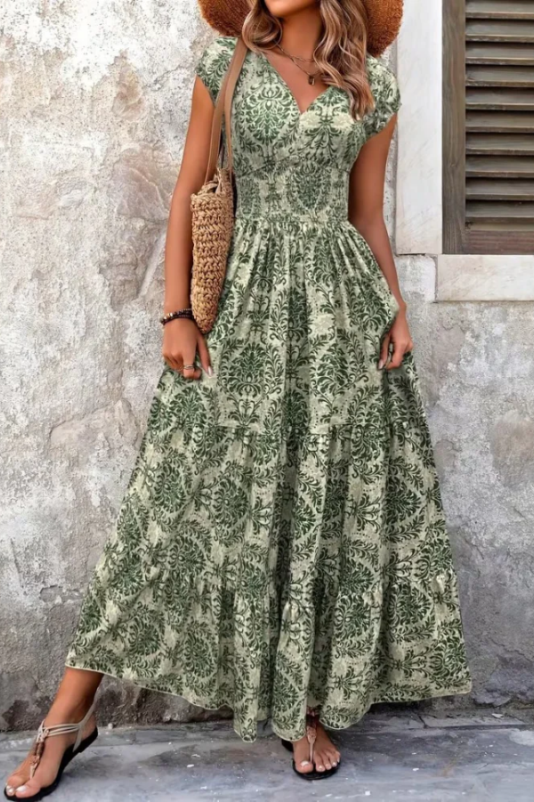 Flowing women's V-neck maxi dress with a vibrant print, ideal for comfortable summer wear and elegant casual style.