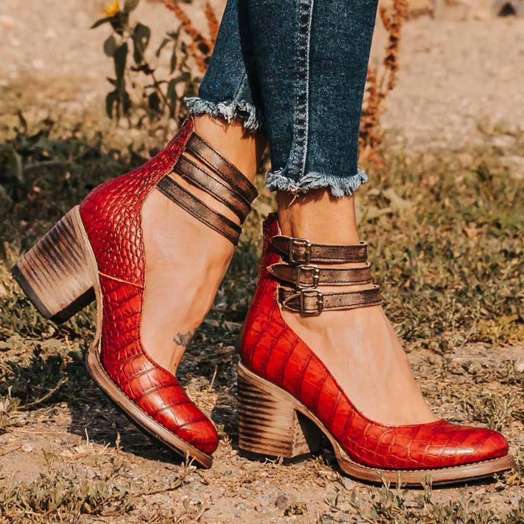 Women's fashion pumps featuring a sturdy block heel, comfortable round toe, and delicate ankle strap detail.
