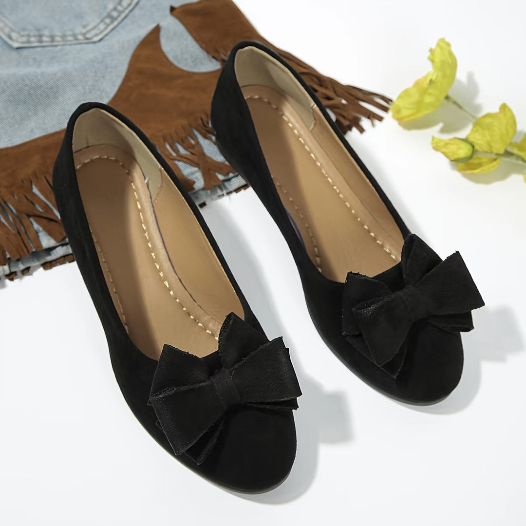 Women's elegant slip-on wedge shoes with stylish bow detail, perfect for comfort & style.