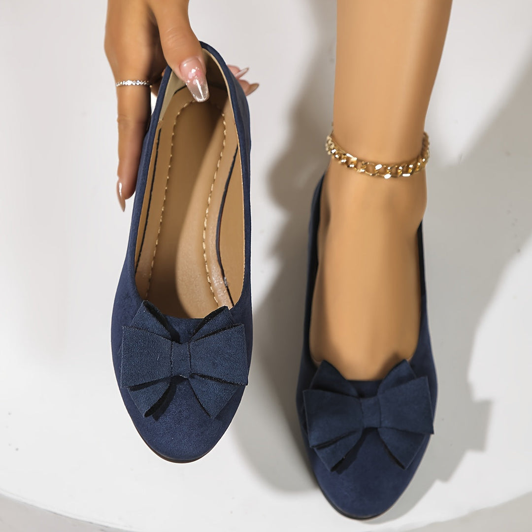 Elegant women's slip-on wedge shoes. Stylish bow detail and comfortable heel. Versatile ladies footwear.