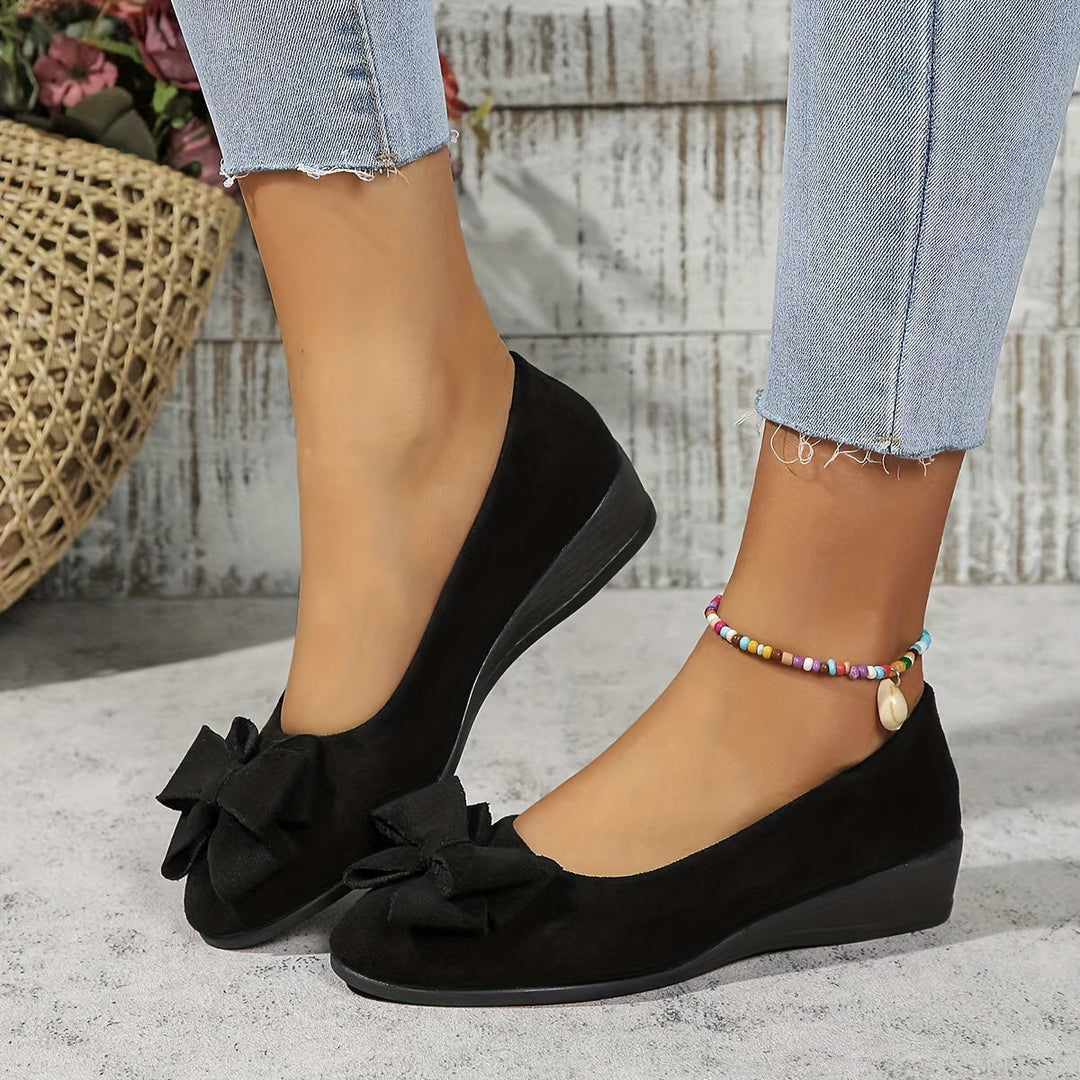 Comfortable women's wedge heels. Slip-on design with a chic bow. Versatile ladies footwear.