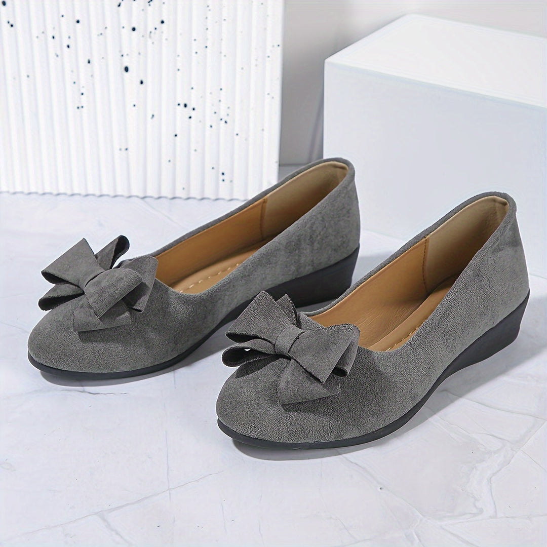 Comfortable slip-on wedge shoes for women with elegant bow detail. Perfect for all-day wear.
