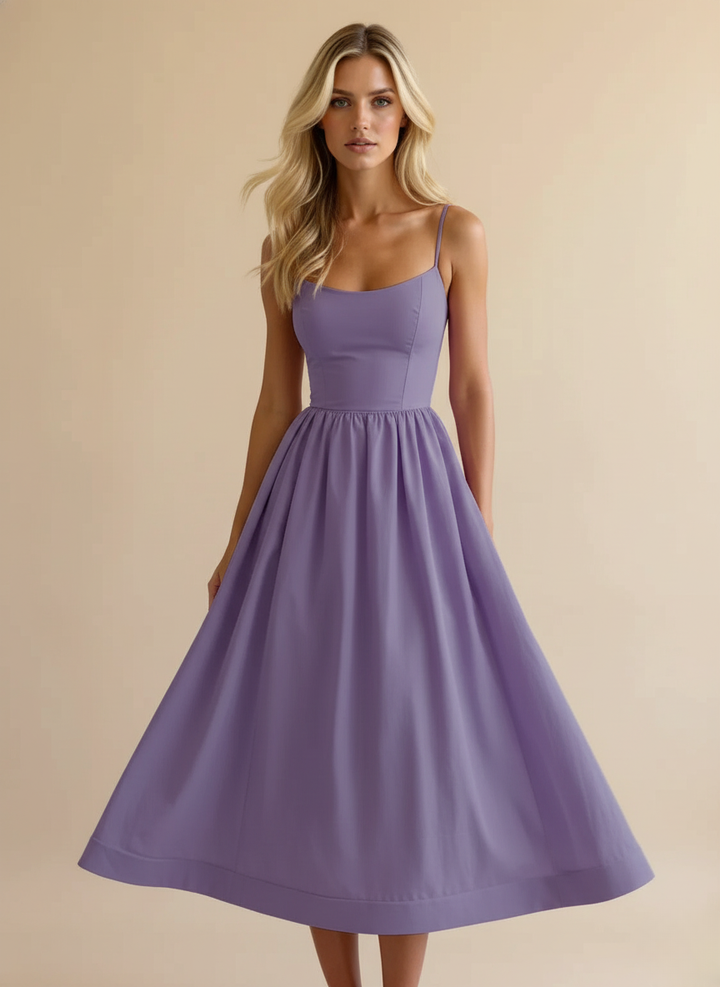 Stylish women's summer midi dress featuring a flattering fit & flare silhouette and delicate spaghetti straps.