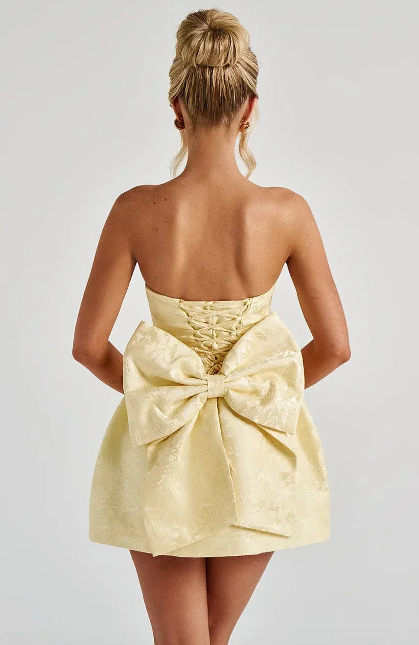 Chic women's strapless mini party dress with an elegant bow back, ideal for cocktail & formal events.