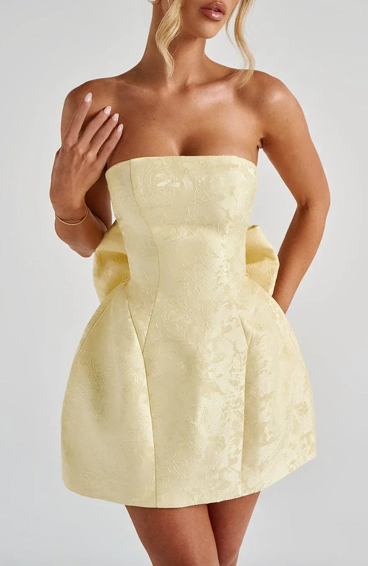 Stylish women's strapless short dress featuring an elegant bow back. Perfect mini dress for special occasions.