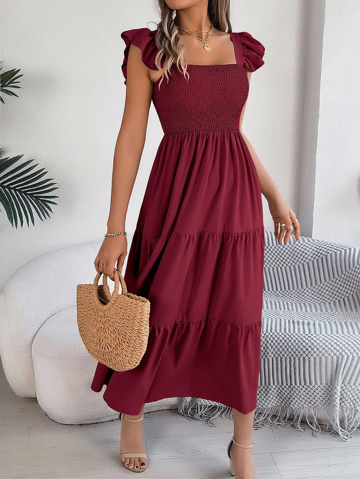 Elegant flowy tiered midi dress for women, ideal as a summer dress, casual wear, or party attire.