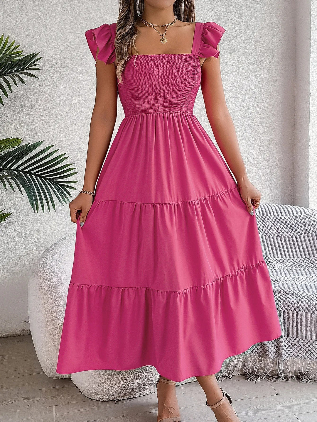 Stylish women's midi tiered dress, flowy and chic, featuring smocked bodice and ruffle sleeves.