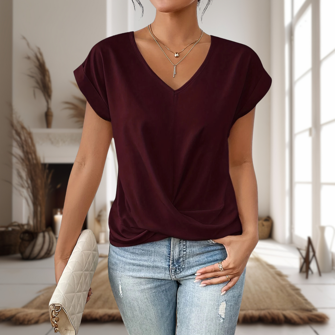 Women's elegant V-neck blouse featuring a chic twisted hem, perfect for casual or work wear. Modern fashion top.