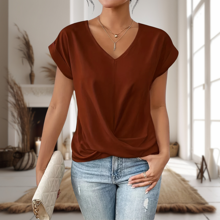 Elegant women's V-neck top with a modern twisted hem design. A stylish and versatile blouse for any occasion.