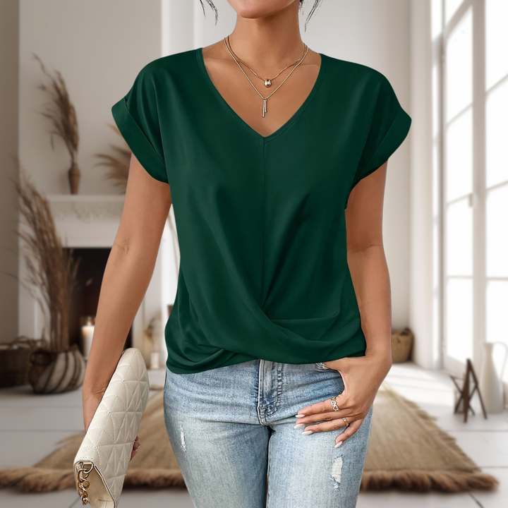 Elegant V-neck women's blouse featuring a chic twisted hem. A versatile and fashionable top for everyday style.