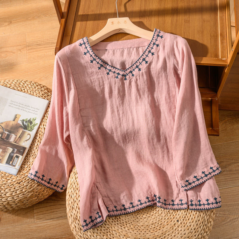 Flowing women's V-neck top featuring elegant embroidery & short sleeves. Versatile comfort for spring & summer fashion.