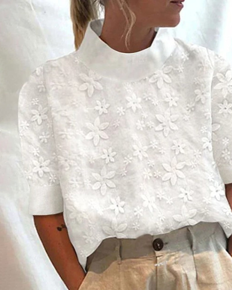 Women's elegant white stand collar blouse with intricate floral embroidery, perfect for a sophisticated look.