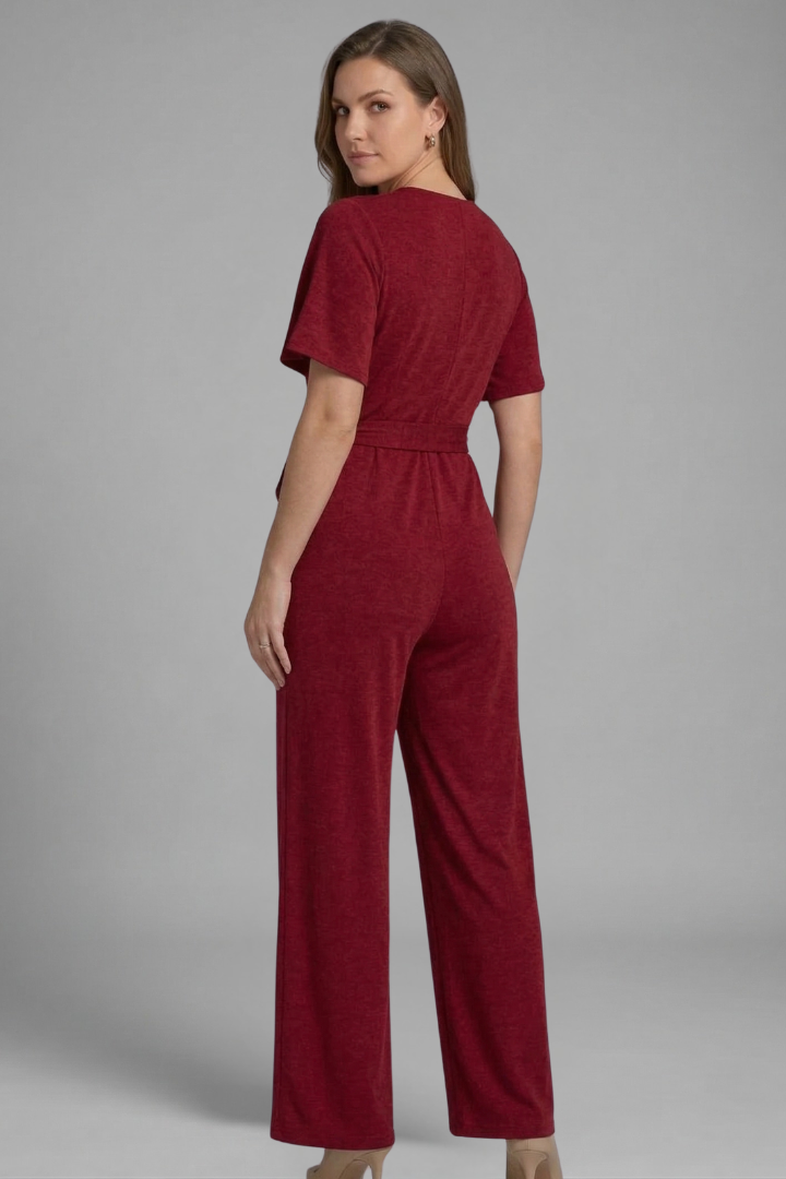 Stylish one-piece women's jumpsuit featuring an elegant wrap front, tie waist, and flowy wide legs.