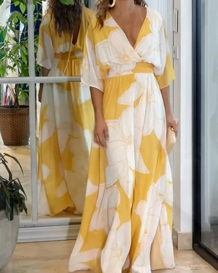 Women's elegant yellow floral maxi dress featuring flutter sleeves, a V-neck, and a beautiful flowy summer silhouette.