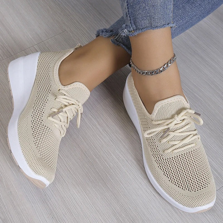 Stylish women's platform wedge sneakers with an elevated sole, perfect for casual fashion.