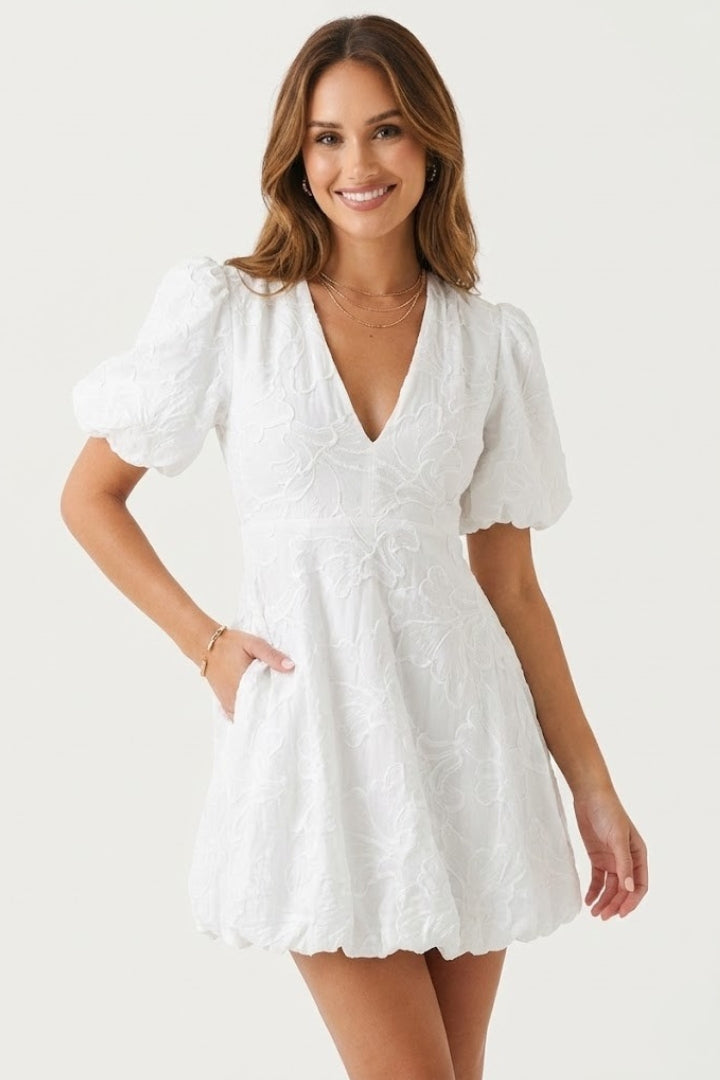 Textured women's V-neck mini dress, embroidered floral pattern, puff sleeves & above-knee cut. Spring/summer style.