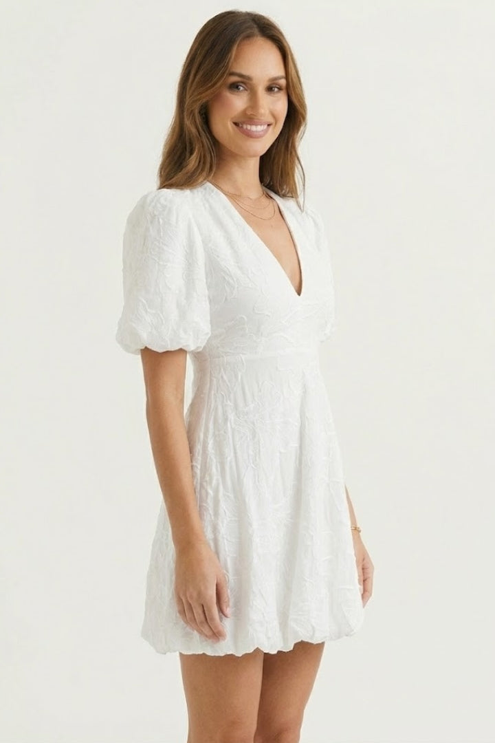 Stylish women's puff sleeve mini dress, embroidered floral design. Chic above-knee summer dress with a textured feel.