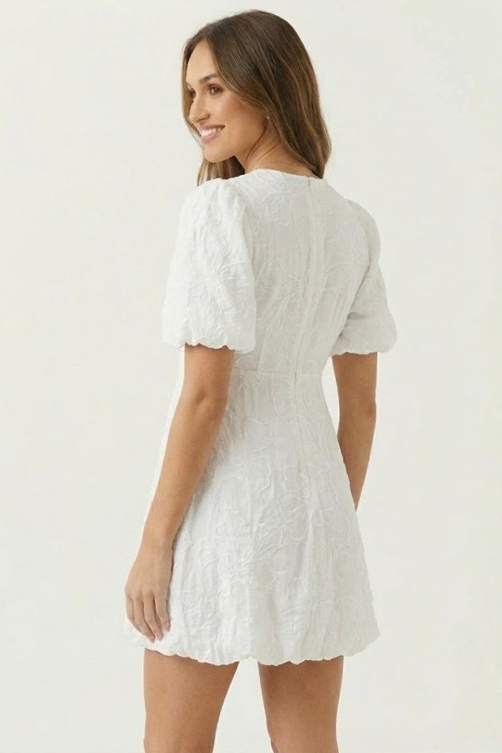 Women's puff sleeve mini dress featuring intricate floral embroidery & a playful bubble hem. Great for warm weather.