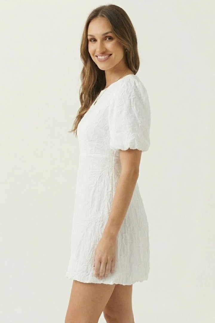 Beautiful women's embroidered mini dress with puff sleeves, V-neck, & bubble hem. A charming spring/summer outfit.