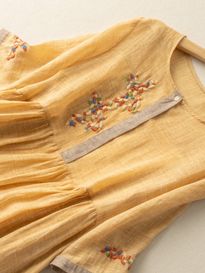 Casual summer women's midi dress, loose fit with charming embroidery, mid sleeves, and a round neckline.