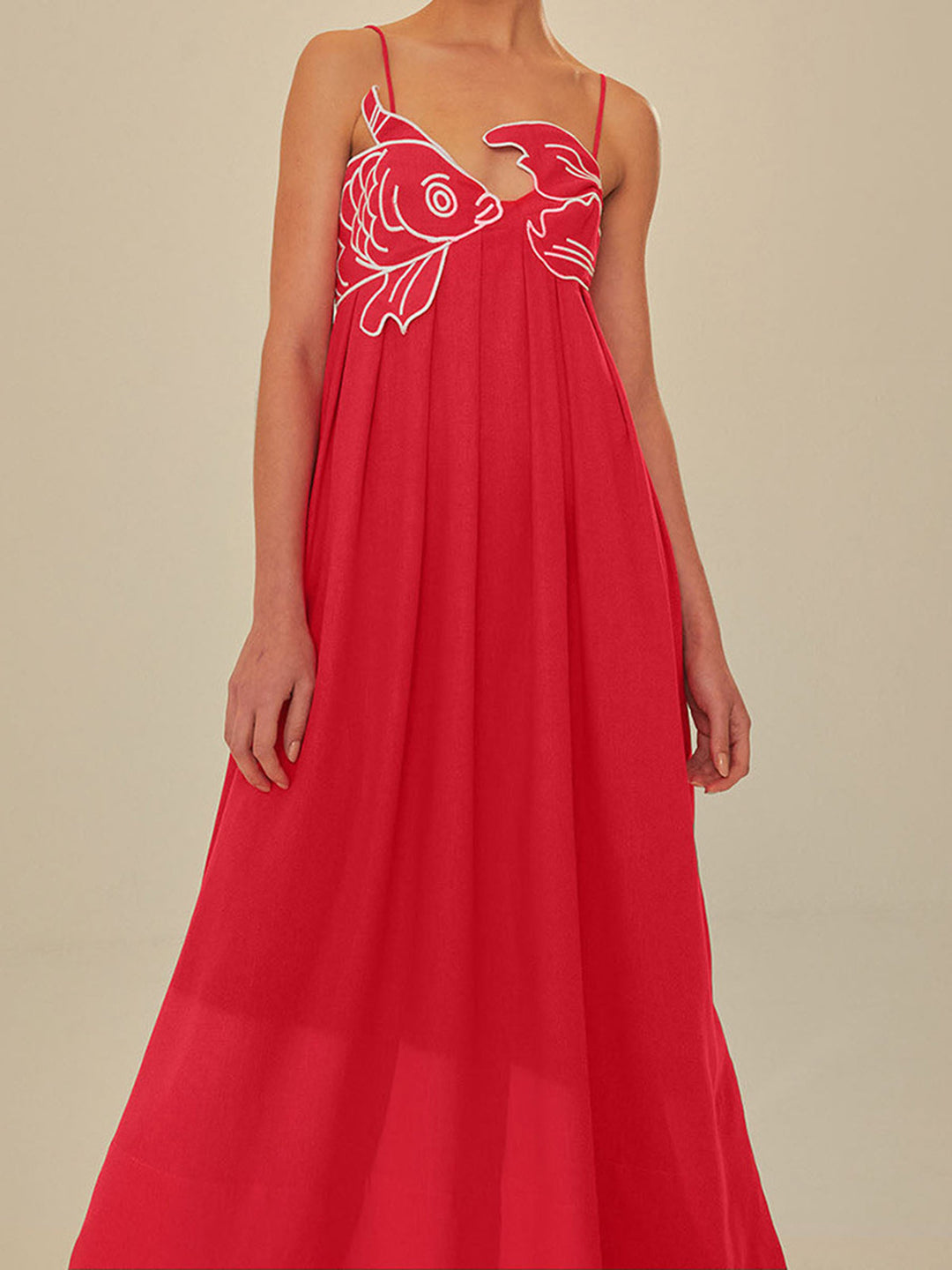 Close-up of intricate floral embroidery on a women's black spaghetti strap maxi summer dress.