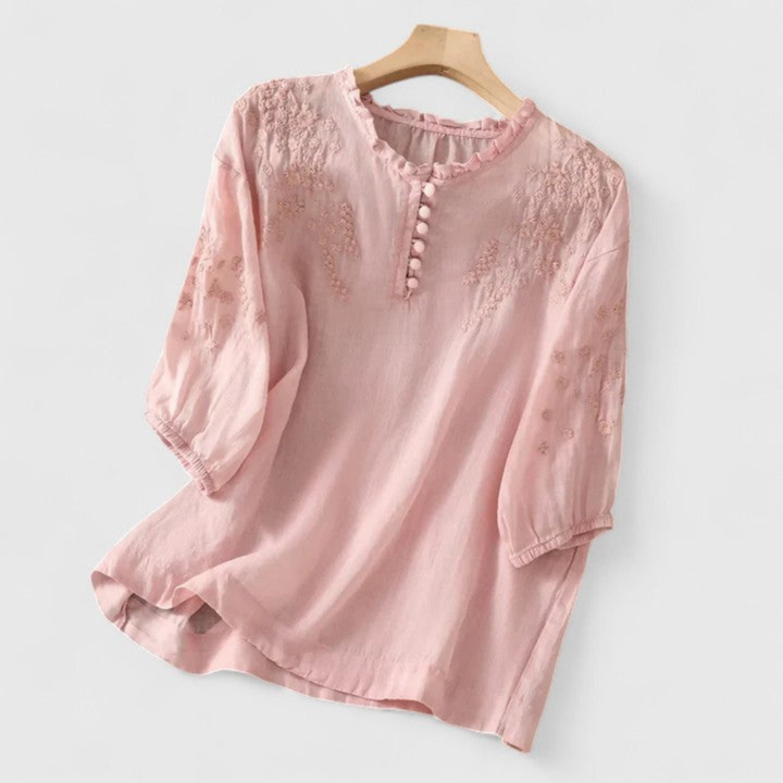Elegant women's lightweight blouse with intricate embroidery, a charming ruffle collar & playful pom-pom details.