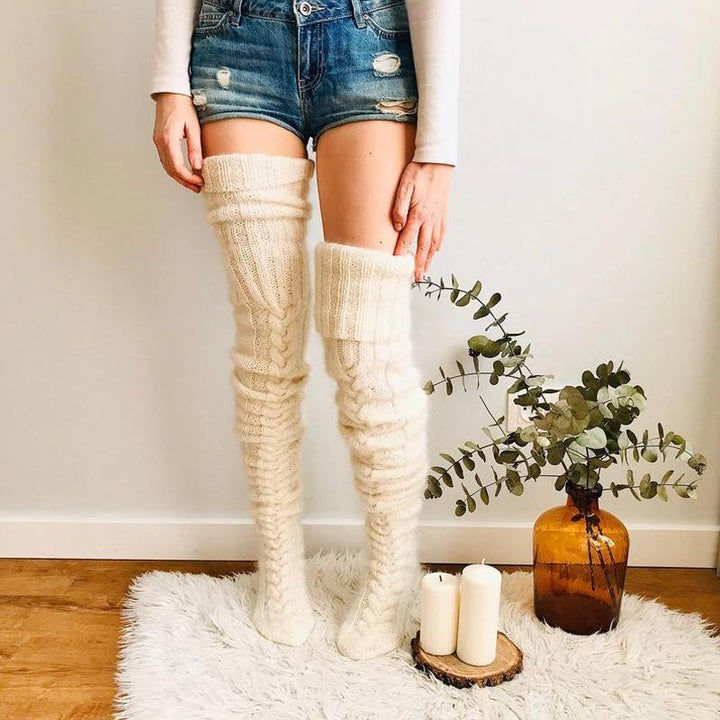 Close-up of a pair of warm, knitted over-knee socks for women, showcasing the soft texture and length.