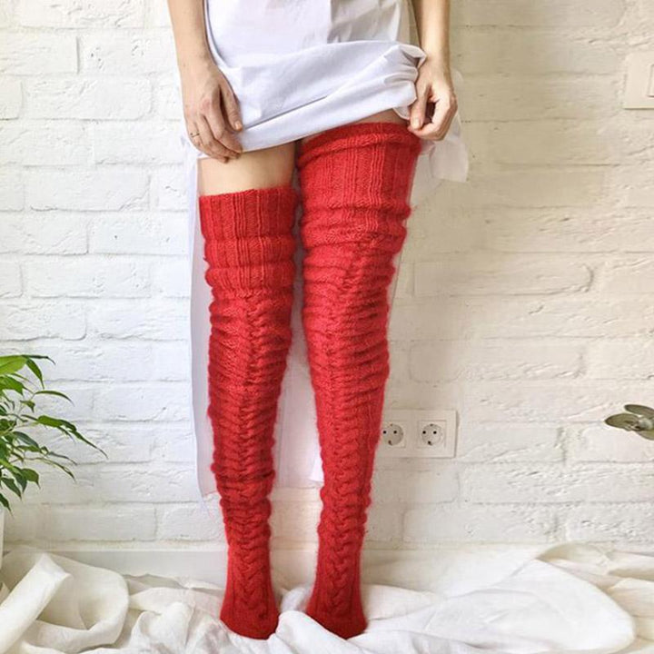 Cozy women's winter over-knee socks, extra long and intricately knitted for maximum warmth and style.