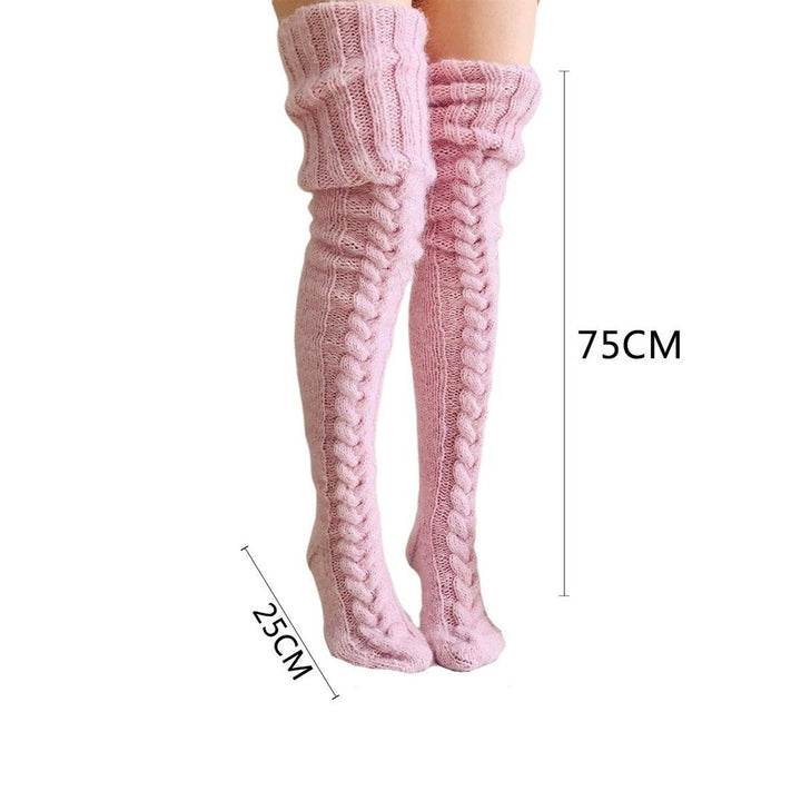 A pair of charcoal grey women's over-knee socks, knitted and extra long for a warm, fashionable winter look.