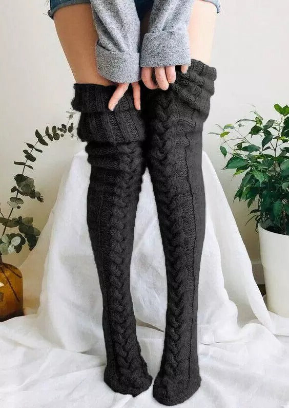 Knitted over-knee socks for women in a classic black, providing extra length and warmth for winter outfits.