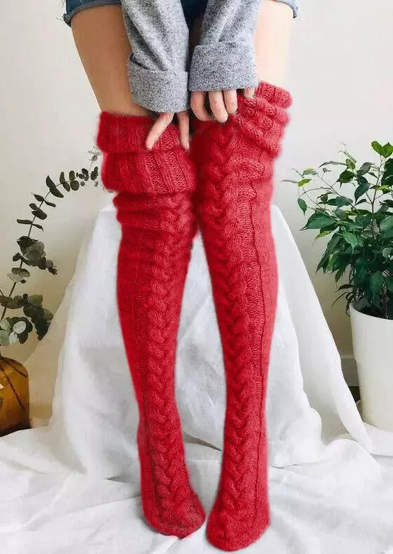 Detailed shot of the knit pattern on warm, extra long women's over-knee socks, perfect for winter fashion.