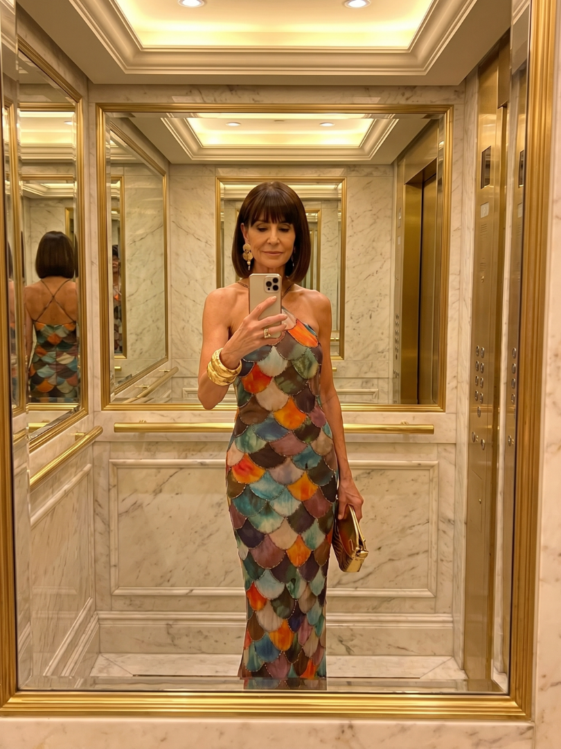 Fashionable women's halter maxi dress, boasting a vibrant geometric print and a sleek, tailored sleeveless design.