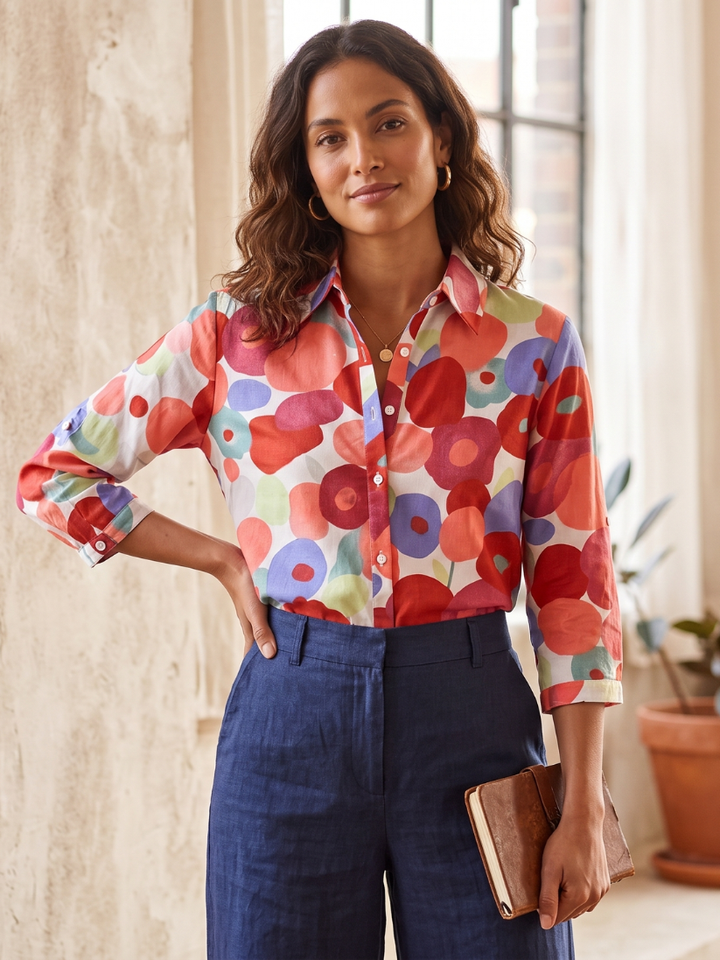 Stylish floral print women's blouse with button-down front & roll-tab sleeves. Ideal for spring layering or summer casual.