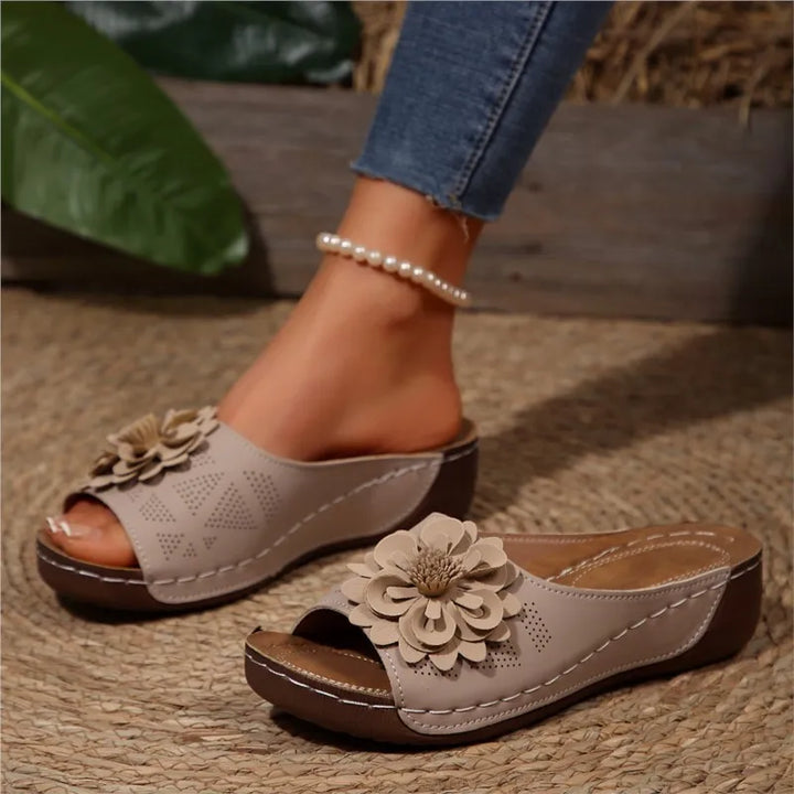 Women's flat floral slide sandals, offering easy on-off access and a comfortable, lightweight feel